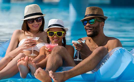 family on raft in pool